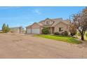 Charming home with a three-car garage, basketball hoop, and storage shed at 14825 Almstead St, Hudson, CO 80642