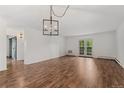 Bright living area with wood floors, shiplap accent wall, and glass doors to outdoor deck at 7020 E Girard Ave # 209, Denver, CO 80224