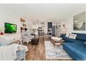 Cozy living room with stylish decor, hardwood floors, and an open layout to the kitchen at 7020 E Girard Ave # 209, Denver, CO 80224