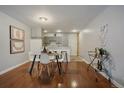 Dining room featuring wood floors, a modern table set, and a convenient bar cart for entertaining guests at 1050 N Corona St # 202, Denver, CO 80218