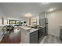 Open kitchen overlooking the living area with stainless steel appliances and a breakfast bar at 1050 N Corona St # 202, Denver, CO 80218