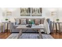 Detailed view of the living room with a comfortable sofa, stylish coffee table and hardwood floors at 2633 Quitman St, Denver, CO 80212