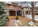 Inviting brick home with a covered porch and outdoor seating at 1614 Gaylord St, Denver, CO 80206