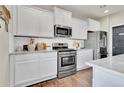 Modern kitchen with white cabinets, stainless steel appliances, and a stylish design at 20727 Park Hollow Dr, Parker, CO 80138