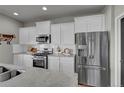 Modern kitchen features white cabinets, stainless steel appliances, and sleek countertops at 20727 Park Hollow Dr, Parker, CO 80138