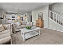 Inviting living room with neutral tones, plush seating, and open floor plan at 20727 Park Hollow Dr, Parker, CO 80138