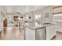 Bright living space featuring a large kitchen island that overlooks the dining and living room at 20727 Park Hollow Dr, Parker, CO 80138