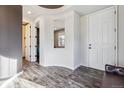 Bright entryway with wood-look floors, a white front door, and a decorative recessed ceiling at 2785 S Lisbon Way, Aurora, CO 80013