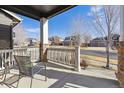 Inviting covered front porch with chairs and a view of the peaceful neighborhood street at 2785 S Lisbon Way, Aurora, CO 80013
