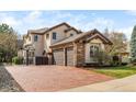 Stunning property featuring a three-car garage, basketball hoop, and a meticulously maintained driveway and lawn at 155 S Poplar St, Denver, CO 80230