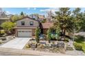 Charming home featuring a two-car garage, brick accents, and beautiful stone-planter landscaping at 14533 W 3Rd Ave, Golden, CO 80401