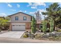 Charming home featuring a two-car garage, brick accents, and well-manicured landscaping at 14533 W 3Rd Ave, Golden, CO 80401