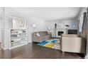 Sunlit living room with hardwood floors, fireplace, and stylish furnishings at 14533 W 3Rd Ave, Golden, CO 80401