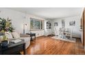 Bright dining area features hardwood floors, a large window, and elegant furnishings at 10983 W Exposition Pl, Lakewood, CO 80226