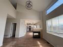 Open living room featuring a fireplace, hardwood floors, and large windows providing ample natural light at 5241 S Shawnee St, Aurora, CO 80015