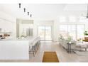 Spacious open-concept kitchen with a large island and seating, flowing into the living area at 3022 Fenton St, Wheat Ridge, CO 80214