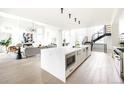 Expansive kitchen with a large island, stainless steel appliances, and open flow to living spaces at 3022 Fenton St, Wheat Ridge, CO 80214