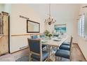 An elegant dining room with a chandelier, bright natural light and seating for six at 10365 E Weaver Cir, Englewood, CO 80111