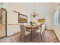 Bright dining room with a chandelier, carpet flooring, and views of the outdoors at 10365 E Weaver Cir, Englewood, CO 80111