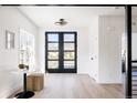 Bright entryway with large front door, light wood floors, and stylish decor at 1880 S Adams St, Denver, CO 80210
