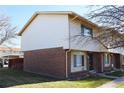 Side view of a brick townhouse with windows and a yard at 13030 E Kansas Pl, Aurora, CO 80012