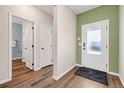 Entryway with hard wood floors and a frosted glass front door provides lots of natural light at 2303 Angus St, Mead, CO 80542