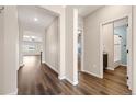 Bright hallway with hard wood floors leading to living spaces and a bathroom at 2303 Angus St, Mead, CO 80542