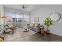Bright living room with large windows, stylish furnishings, and dark wood floors at 2525 Arapahoe St # Rd315, Denver, CO 80205
