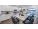 Modern kitchen featuring white cabinets, stainless steel appliances, and a large granite island at 3899 N Shaenee St, Aurora, CO 80019