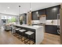 Bright, modern kitchen with a large island, quartz countertops, and stainless steel appliances at 2395 N Emerson St, Denver, CO 80205