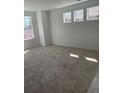 Carpeted bedroom with three large windows providing ample natural light at 6750 Juniper Dr, Thornton, CO 80602