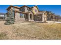 Beautiful stone accented home with manicured front yard and mature landscaping at 11602 Pine Canyon Dr, Parker, CO 80138