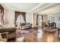 Spacious living room and dining area with hardwood floors, elegant decor, and natural light at 11602 Pine Canyon Dr, Parker, CO 80138