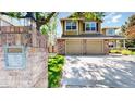 Charming two-story home with a well-maintained lawn, mature tree, and a brick mailbox feature at 2980 E 135Th Dr, Thornton, CO 80241