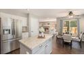 Open kitchen featuring stainless steel appliances, granite countertops, and an adjacent dining area at 2980 E 135Th Dr, Thornton, CO 80241
