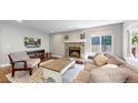 Comfortable living room boasts a cozy fireplace, plush seating, and natural light at 2980 E 135Th Dr, Thornton, CO 80241