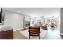 Spacious living room with a fireplace, comfortable seating, and an open layout at 2980 E 135Th Dr, Thornton, CO 80241