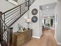 Beautiful foyer with wood floors, open staircase, and stylish decor at 6244 N Lisbon St, Aurora, CO 80019