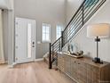 Bright and airy foyer with wood floors, staircase, and plenty of natural light at 6244 N Lisbon St, Aurora, CO 80019