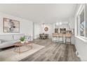 Open-concept living space showcasing stylish decor with a sofa, dining area, bar seating, and modern kitchen at 3313 Jasmine St, Denver, CO 80207