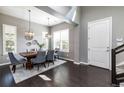 Dining room featuring a wooden table, gray chairs, modern light fixtures, and plantation shutters at 578 Sage Grouse Cir, Castle Rock, CO 80109