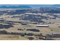 Panoramic view of a sprawling landscape with several homes in the distance at 5549 Lake Gulch Rd, Castle Rock, CO 80104
