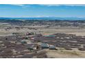 Distant aerial view of home with snowy mountain range in the distance at 5549 Lake Gulch Rd, Castle Rock, CO 80104