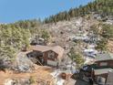 View of the house and wooded surroundings at 113 Oakdale Dr, Palmer Lake, CO 80133