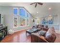 Bright living room featuring vaulted ceiling, large windows with scenic views, and comfortable seating at 113 Oakdale Dr, Palmer Lake, CO 80133