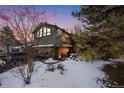 Two-story house with a balcony and snow-covered landscaping in the front yard at 2212 Juniper Ct, Boulder, CO 80304