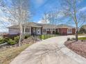 Inviting single-story home features a wide driveway, meticulous landscaping and a charming walkway at 260 Dekker Dr, Golden, CO 80401