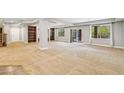 Spacious basement area featuring carpeted floors, lots of natural light, and custom built-in bookshelves at 6085 Nile Cir, Golden, CO 80403