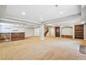 Finished basement includes carpeted floors, recessed lighting, and a wet bar with wood cabinetry at 6085 Nile Cir, Golden, CO 80403