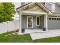 Inviting covered front porch with lovely plants and view of the exterior of the house at 5570 Nepal St, Denver, CO 80249